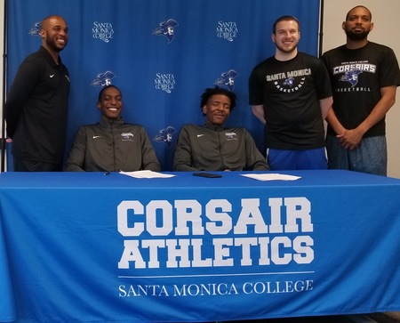 SMC Men's Basketball coaches join sophomores Marcus Harris and Kyle Young on their scholarship signing day.  Both players will head to Florida Memorial University.